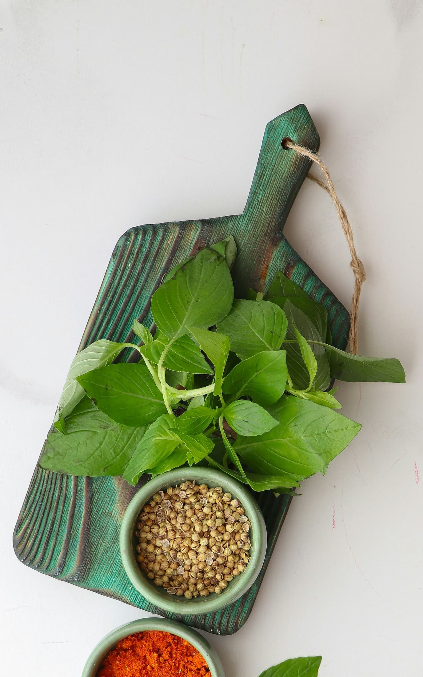 Bowls of coriander seeds and ground spices